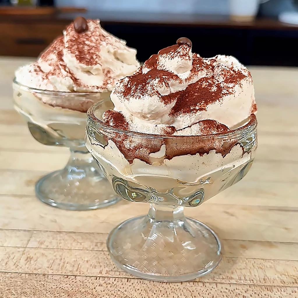 Crema al Caffè served in a glass with cocoa powder and espresso beans, a light and airy Italian coffee dessert.