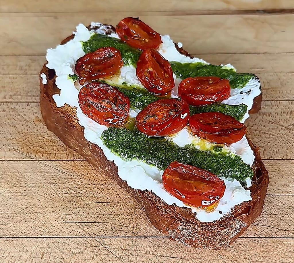 crostone made with stracciatella, confit cherry tomatoes and basil pesto