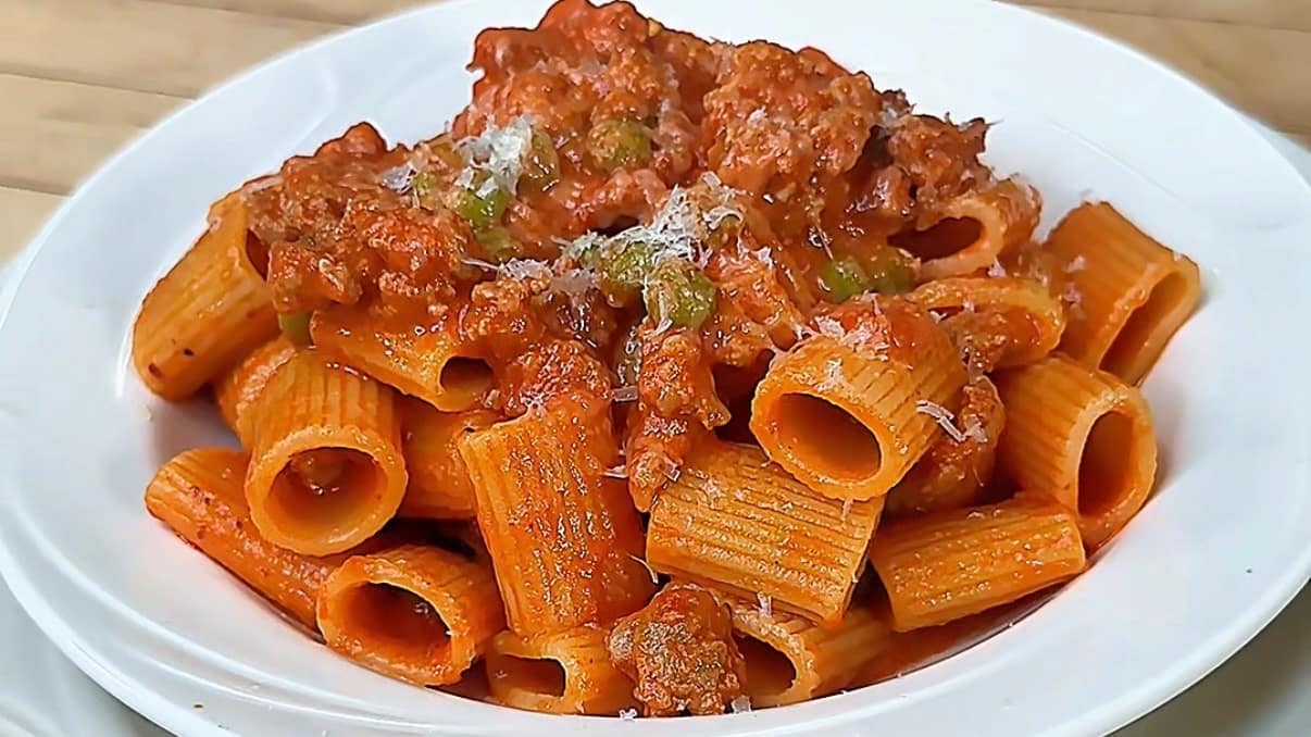 Mezzi Rigatoni with Sausage and Peas in a creamy tomato sauce finished with Parmigiano Reggiano