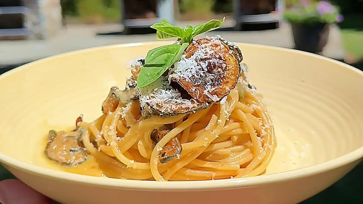 Spaghetti alla Nerano made with fried zucchini, Parmigiano Reggiano, basil, and extra virgin olive oil.