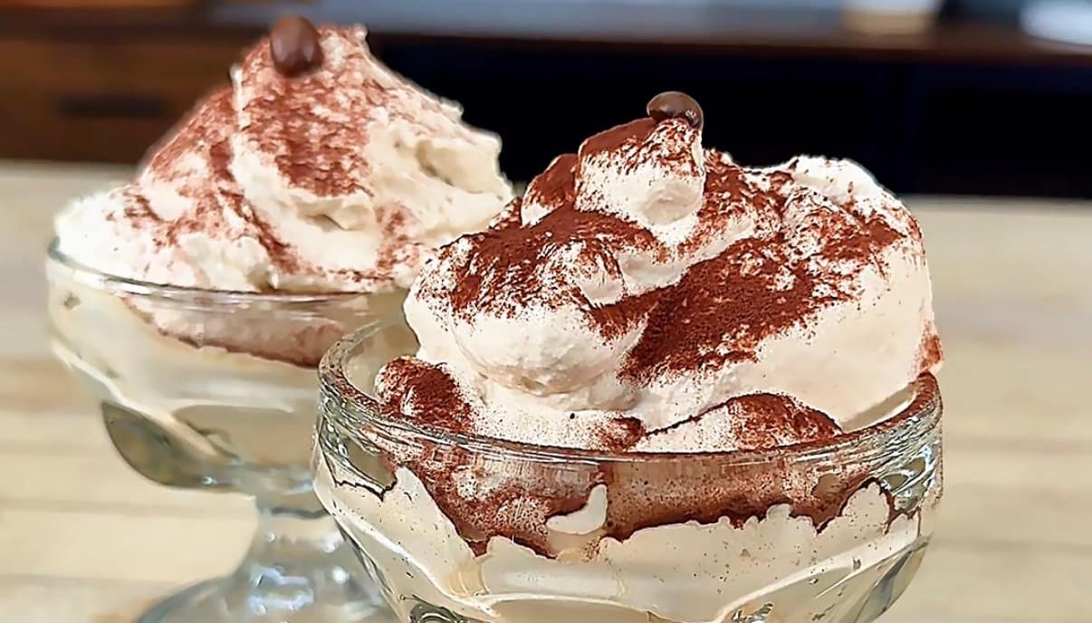 Crema al Caffè served in a glass with cocoa powder and espresso beans, a light and airy Italian coffee dessert.