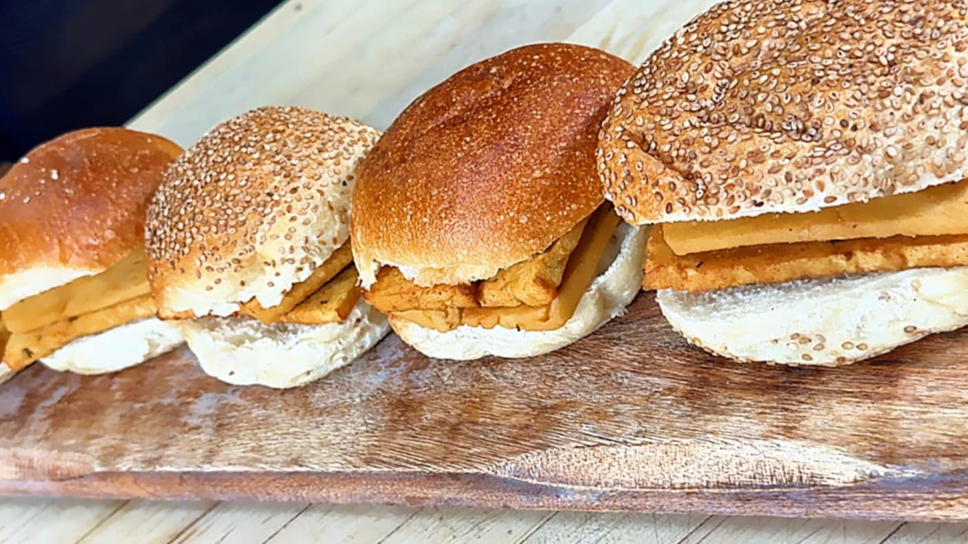 Sicilian Panelle served on a sesame roll with fresh lemon, traditional Palermo-style chickpea fritters.
