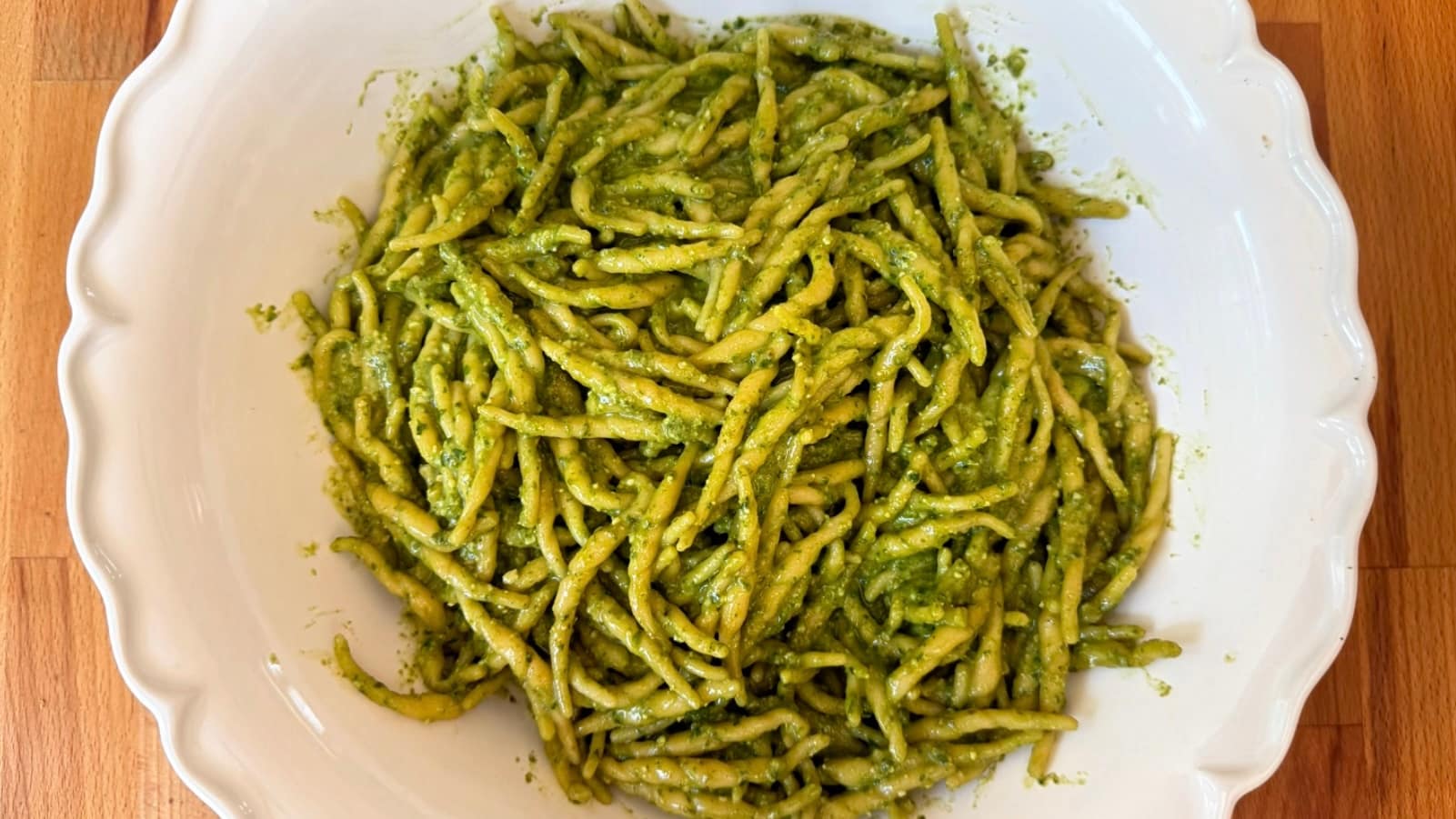 Trofie al Pesto made with fresh basil pesto, Parmigiano Reggiano, pine nuts, and Ligurian trofie pasta.