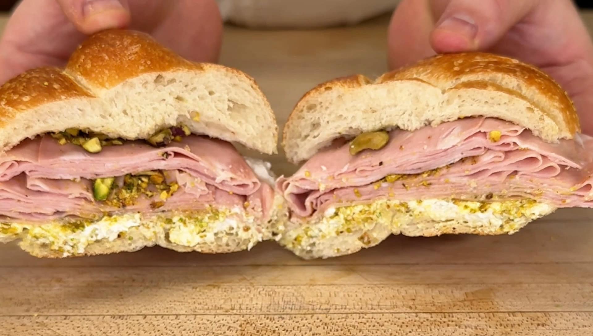Mortadella sandwich with stracciatella cheese, pistachio pesto, and crushed pistachios served on fresh Italian bread.