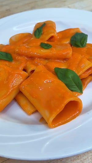 Paccheri alla Vittorio tossed in a silky tomato sauce with basil and Parmigiano Reggiano.