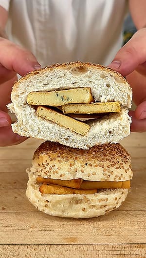Sicilian Panelle served on a sesame roll with fresh lemon, traditional Palermo-style chickpea fritters.