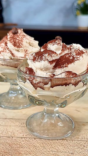 Crema al Caffè served in a glass with cocoa powder and espresso beans, a light and airy Italian coffee dessert.