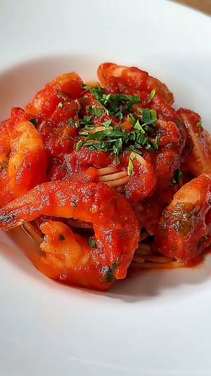 Shrimp Fra Diavolo served over linguine with a spicy tomato sauce, garlic, parsley, and crushed red pepper.
