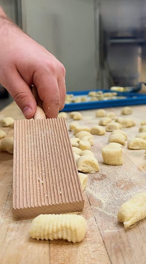 homemade potato gnocchi on a floured surface ready to cook