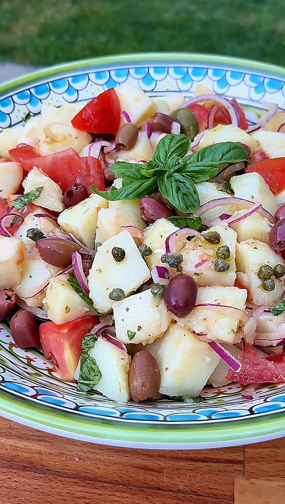 Insalata Pantesca with red potatoes, tomatoes, capers, olives, red onion, basil, and extra virgin olive oil.