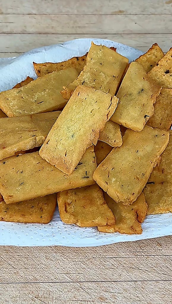 Sicilian Panelle served on a sesame roll with fresh lemon, traditional Palermo-style chickpea fritters.