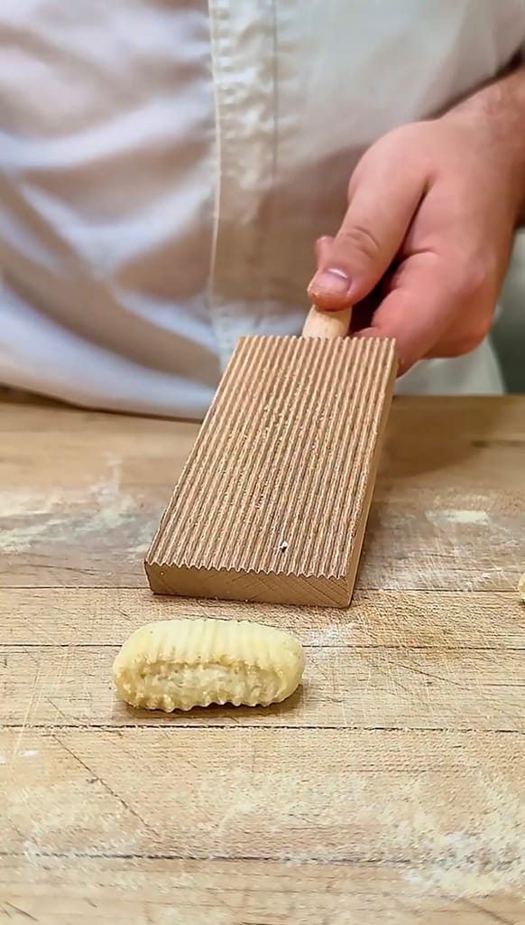 homemade potato gnocchi on a floured surface ready to cook