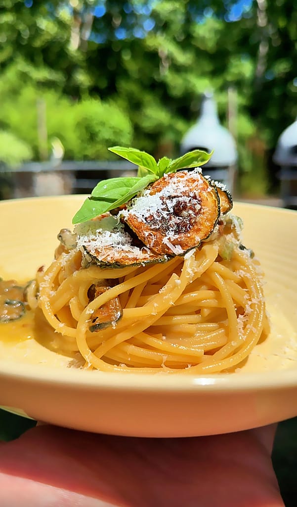 Spaghetti alla Nerano made with fried zucchini, Parmigiano Reggiano, basil, and extra virgin olive oil.