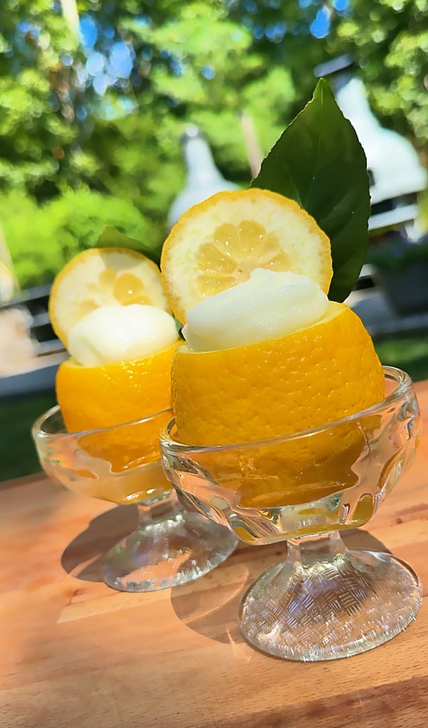 Sorbetto al Limone served inside frozen lemon shells and garnished with fresh mint.