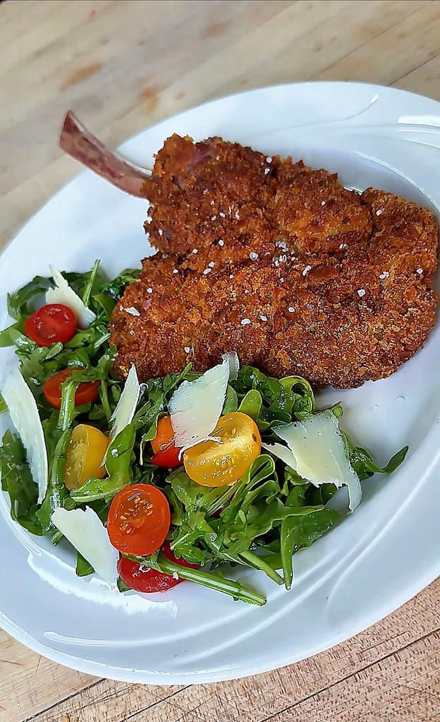 Veal Chop with an arugula salad with cherry tomatoes and shaved parmigiano
