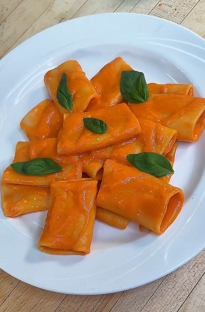 Paccheri alla Vittorio tossed in a silky tomato sauce with basil and Parmigiano Reggiano.