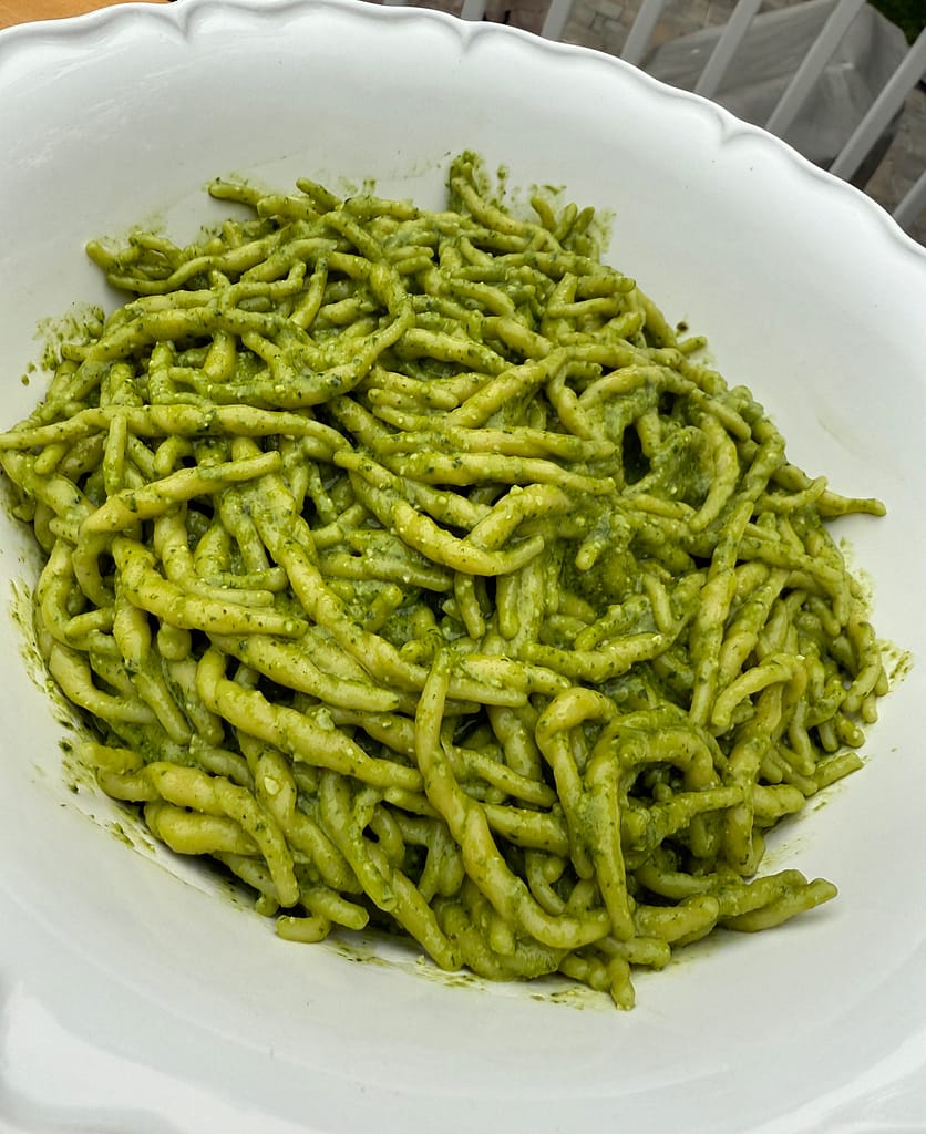 Trofie al Pesto made with fresh basil pesto, Parmigiano Reggiano, pine nuts, and Ligurian trofie pasta.